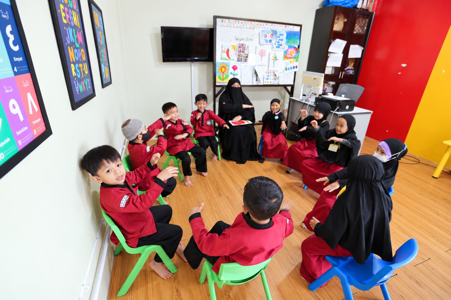 Guru dan murid TKIT belajar bersama dalam lingkaran; foto diolah secara digital.